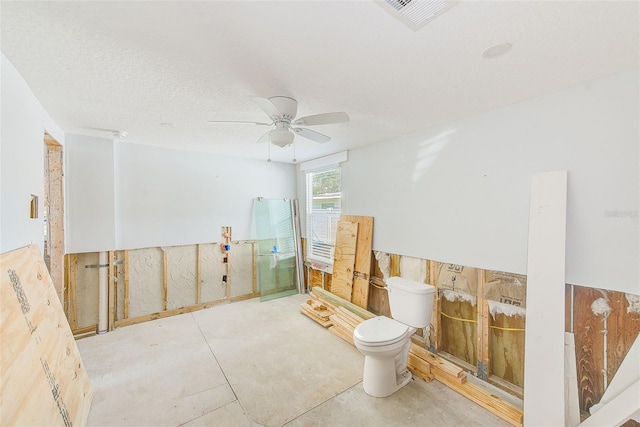 112 11th Ave, Indian Rocks Beach, FL 33785 - bathroom with toilet, a ceiling fan, and concrete floors