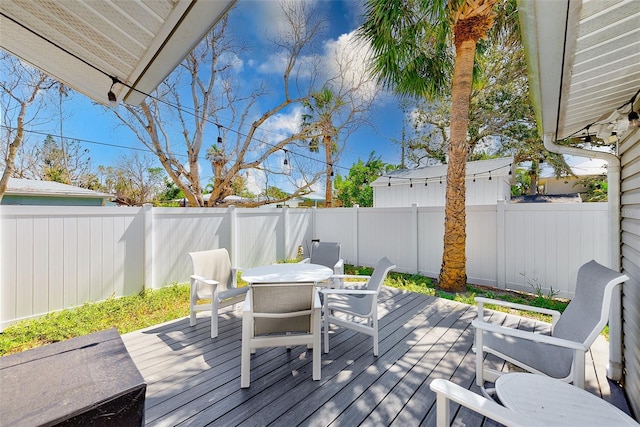 112 11th Ave, Indian Rocks Beach, FL 33785 - deck with outdoor dining area and a fenced backyard
