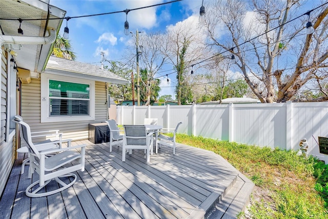 112 11th Ave, Indian Rocks Beach, FL 33785 - wooden deck with outdoor dining area and a fenced backyard