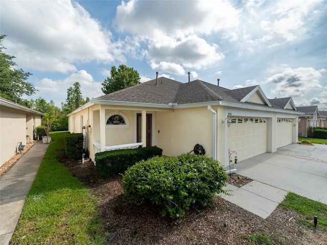 31201 Shaker Cir, Wesley Chapel, FL 33543 - view of front of house with a garage, stucco siding, a shingled roof, and concrete driveway