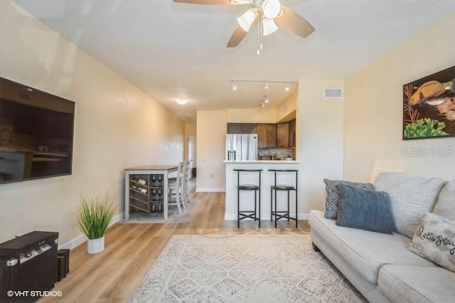 4325 58th Way N Unit 1527, Kenneth City, FL 33709 - living room with light wood-style flooring, baseboards, and ceiling fan