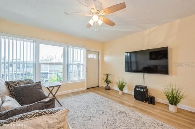 4325 58th Way N Unit 1527, Kenneth City, FL 33709 - living area featuring baseboards, wood finished floors, and ceiling fan
