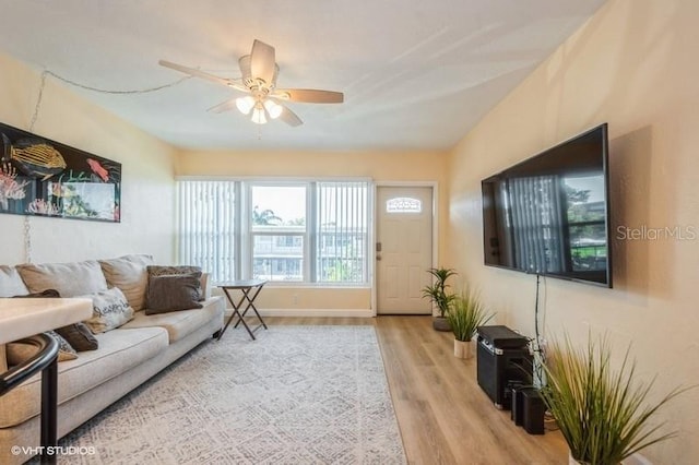 4325 58th Way N Unit 1527, Kenneth City, FL 33709 - living room featuring wood finished floors, a ceiling fan, and baseboards