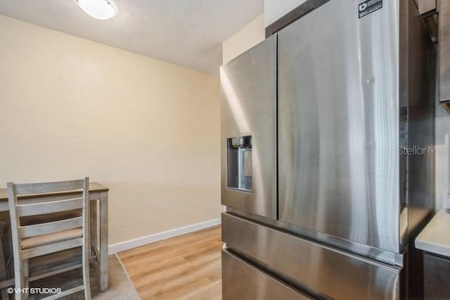 4325 58th Way N Unit 1527, Kenneth City, FL 33709 - kitchen with stainless steel fridge with ice dispenser, light wood-style floors, and baseboards