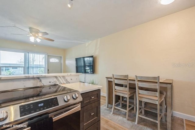 4325 58th Way N Unit 1527, Kenneth City, FL 33709 - kitchen with electric stove, light wood finished floors, baseboards, and ceiling fan