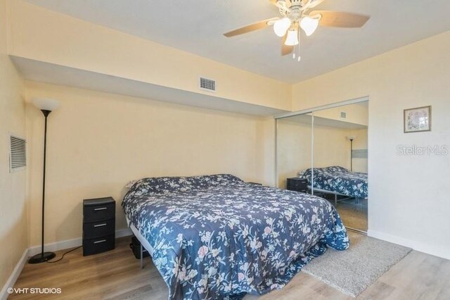 4325 58th Way N Unit 1527, Kenneth City, FL 33709 - bedroom featuring wood finished floors, a closet, and baseboards