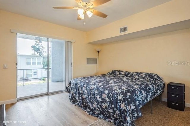 4325 58th Way N Unit 1527, Kenneth City, FL 33709 - bedroom with access to exterior, wood finished floors, baseboards, and ceiling fan