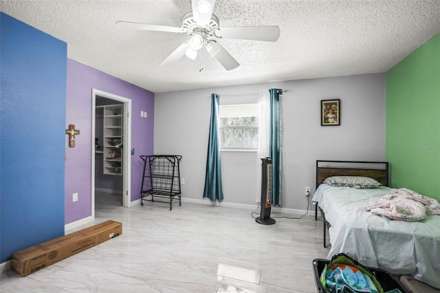 2174 62nd St N, Clearwater, FL 33760 - bedroom with a textured ceiling, a spacious closet, marble look tiles, a ceiling fan, and a closet