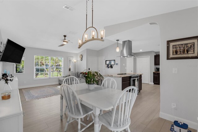 12838 Tallowood Dr, Riverview, FL 33579 - dining area featuring baseboards, light wood-style floors, and a chandelier