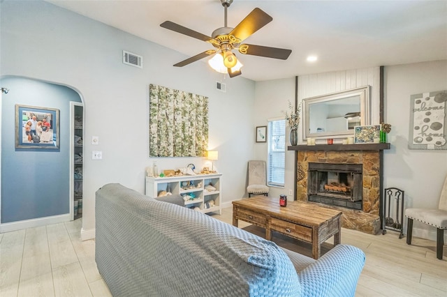12838 Tallowood Dr, Riverview, FL 33579 - living area with a stone fireplace, light wood-type flooring, ceiling fan, baseboards, and recessed lighting