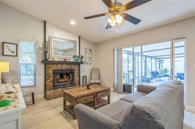 12838 Tallowood Dr, Riverview, FL 33579 - living room with healthy amount of natural light, ceiling fan, a stone fireplace, lofted ceiling, and light wood-style flooring