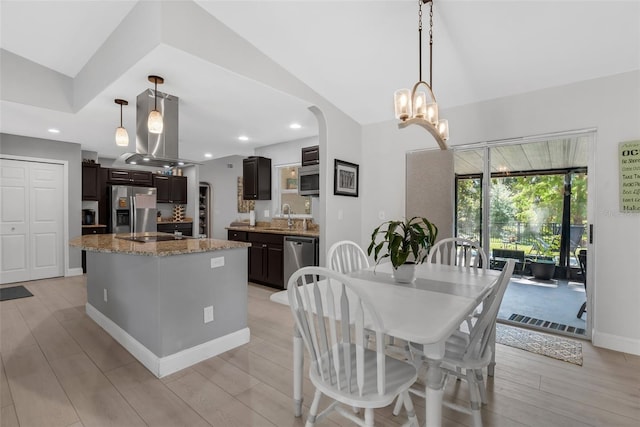12838 Tallowood Dr, Riverview, FL 33579 - dining room with lofted ceiling, arched walkways, light wood-style floors, recessed lighting, and baseboards