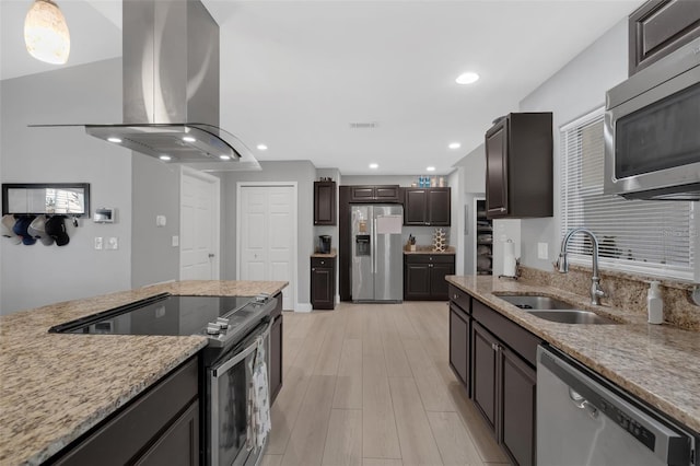 12838 Tallowood Dr, Riverview, FL 33579 - kitchen featuring appliances with stainless steel finishes, island exhaust hood, a sink, light wood finished floors, and light stone countertops