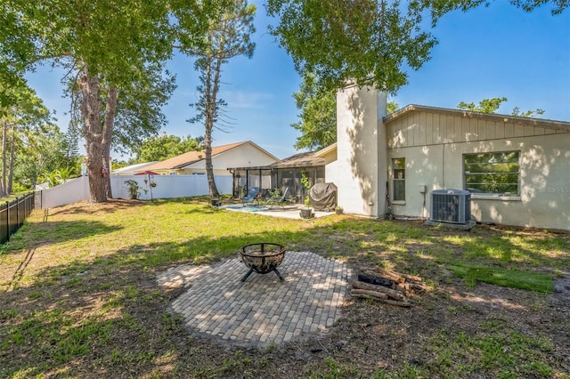 12838 Tallowood Dr, Riverview, FL 33579 - back of property with a fire pit, a patio, central AC unit, a chimney, and a sunroom