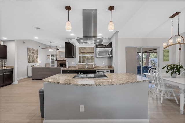 12838 Tallowood Dr, Riverview, FL 33579 - kitchen with lofted ceiling, appliances with stainless steel finishes, island exhaust hood, a sink, and light stone countertops