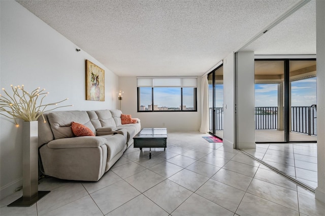 6322 Palma Del Mar Blvd S Unit 1107, Saint Petersburg, FL 33715 - living area featuring a textured ceiling, light tile patterned flooring, and baseboards