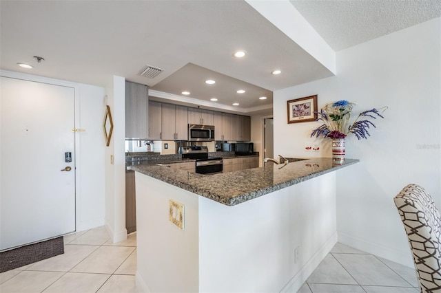 6322 Palma Del Mar Blvd S Unit 1107, Saint Petersburg, FL 33715 - kitchen featuring stainless steel appliances, recessed lighting, dark stone counters, and light tile patterned floors