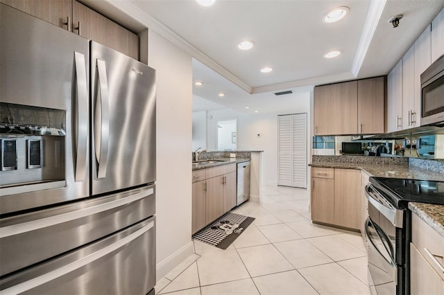 6322 Palma Del Mar Blvd S Unit 1107, Saint Petersburg, FL 33715 - kitchen featuring stainless steel appliances, light tile patterned floors, ornamental molding, a tray ceiling, and stone countertops