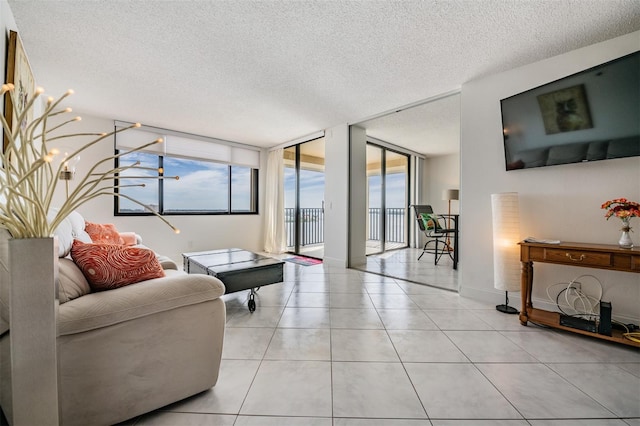 6322 Palma Del Mar Blvd S Unit 1107, Saint Petersburg, FL 33715 - living room with a textured ceiling, light tile patterned flooring, and floor to ceiling windows