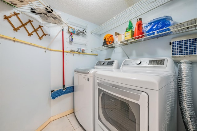 6322 Palma Del Mar Blvd S Unit 1107, Saint Petersburg, FL 33715 - laundry room featuring washer and dryer, light tile patterned floors, and a textured ceiling