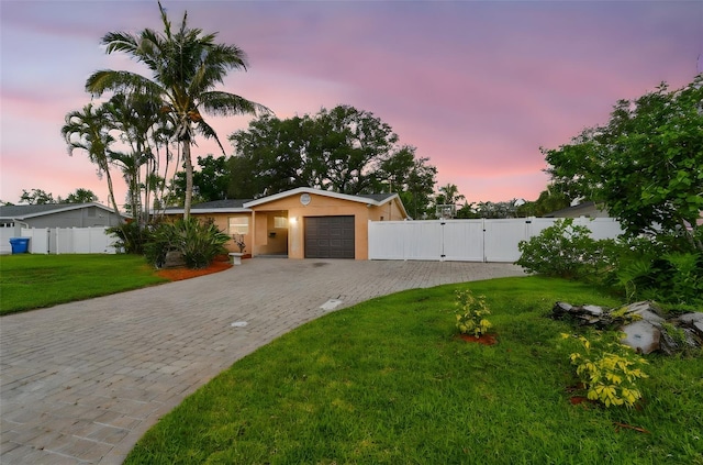 4400 Helena St NE, Saint Petersburg, FL 33703 - view of front of home featuring decorative driveway, a gate, an attached garage, and stucco siding