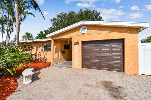 4400 Helena St NE, Saint Petersburg, FL 33703 - view of front of house featuring stucco siding and driveway