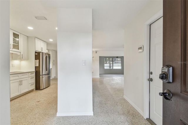 4400 Helena St NE, Saint Petersburg, FL 33703 - kitchen featuring freestanding refrigerator, glass insert cabinets, white cabinets, recessed lighting, and baseboards