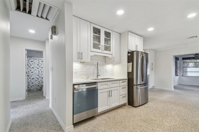 4400 Helena St NE, Saint Petersburg, FL 33703 - kitchen featuring stainless steel appliances, a sink, white cabinets, glass insert cabinets, and recessed lighting
