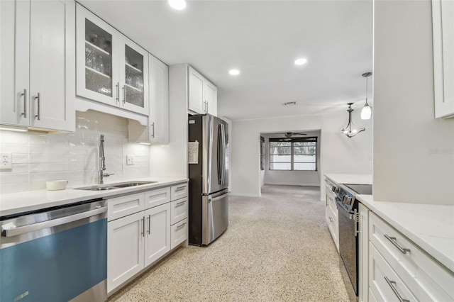 4400 Helena St NE, Saint Petersburg, FL 33703 - kitchen with stainless steel appliances, a sink, tasteful backsplash, white cabinetry, and glass insert cabinets