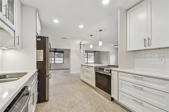 4400 Helena St NE, Saint Petersburg, FL 33703 - kitchen featuring stainless steel appliances, recessed lighting, tasteful backsplash, light countertops, and white cabinetry