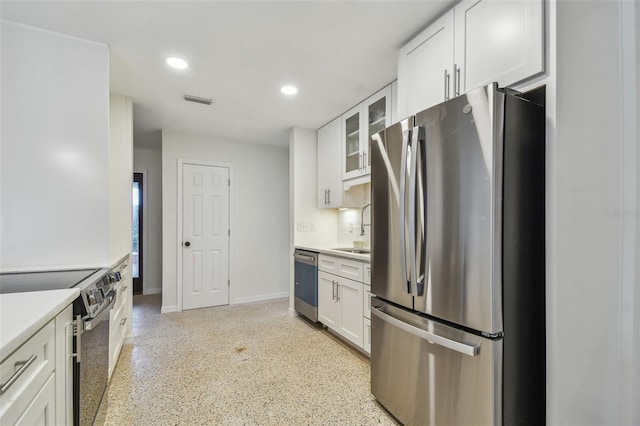 4400 Helena St NE, Saint Petersburg, FL 33703 - kitchen featuring appliances with stainless steel finishes, a sink, white cabinetry, and recessed lighting