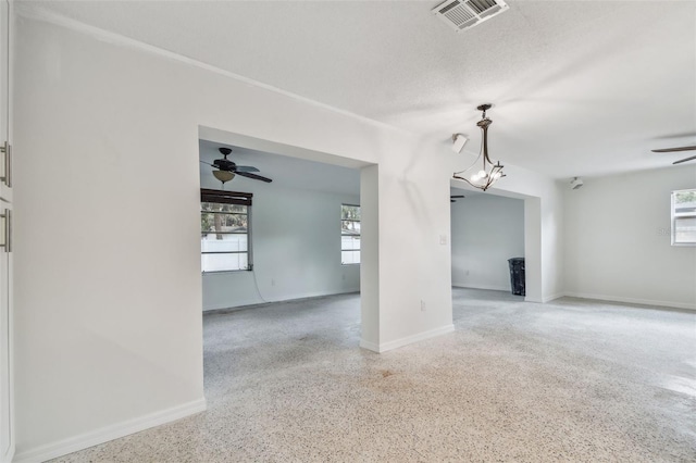 4400 Helena St NE, Saint Petersburg, FL 33703 - unfurnished living room featuring ceiling fan, speckled floor, and baseboards