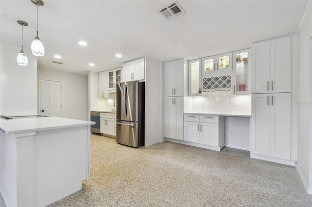 4400 Helena St NE, Saint Petersburg, FL 33703 - kitchen with freestanding refrigerator, recessed lighting, white cabinetry, backsplash, and dark speckled floor