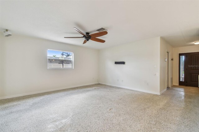 4400 Helena St NE, Saint Petersburg, FL 33703 - empty room with speckle patterned floor, ceiling fan, and baseboards
