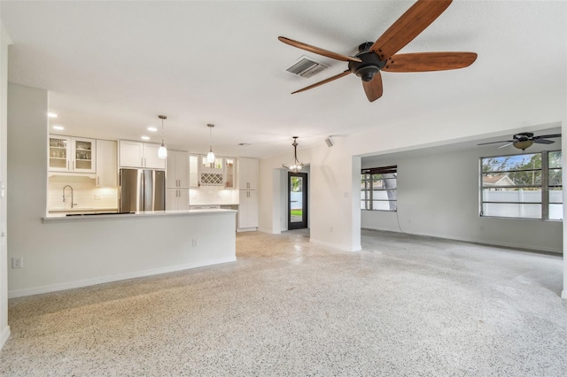 4400 Helena St NE, Saint Petersburg, FL 33703 - unfurnished living room featuring ceiling fan, baseboards, healthy amount of natural light, and recessed lighting