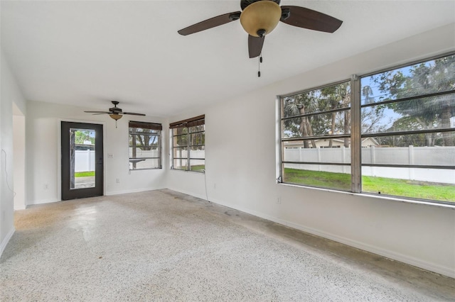 4400 Helena St NE, Saint Petersburg, FL 33703 - unfurnished room with speckle patterned floor, baseboards, and a ceiling fan