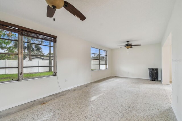 4400 Helena St NE, Saint Petersburg, FL 33703 - unfurnished room featuring a ceiling fan, speckled floor, and baseboards