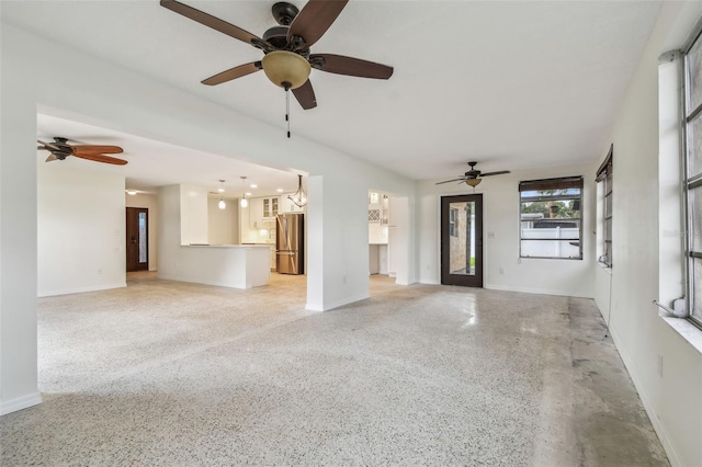 4400 Helena St NE, Saint Petersburg, FL 33703 - unfurnished living room featuring dark aggregate flooring, ceiling fan, and baseboards