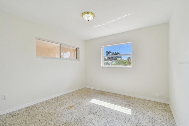 4400 Helena St NE, Saint Petersburg, FL 33703 - empty room with speckled floor and baseboards
