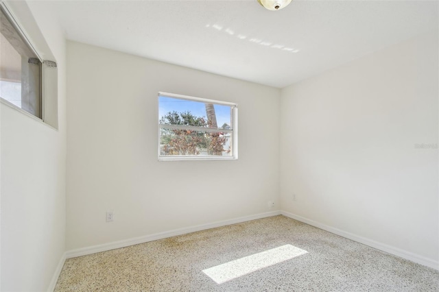 4400 Helena St NE, Saint Petersburg, FL 33703 - unfurnished room featuring speckle patterned floor and baseboards