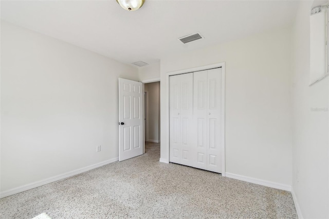 4400 Helena St NE, Saint Petersburg, FL 33703 - unfurnished bedroom with speckle patterned floor, baseboards, and a closet