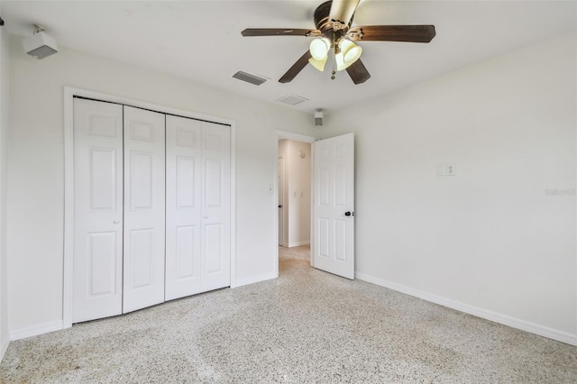 4400 Helena St NE, Saint Petersburg, FL 33703 - unfurnished bedroom with speckle patterned floor, a closet, baseboards, and ceiling fan