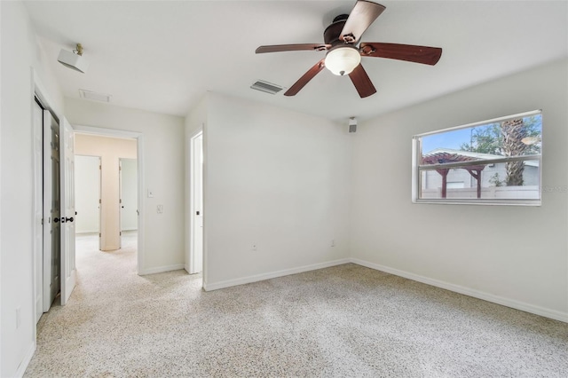 4400 Helena St NE, Saint Petersburg, FL 33703 - empty room with dark speckled floor, baseboards, and a ceiling fan