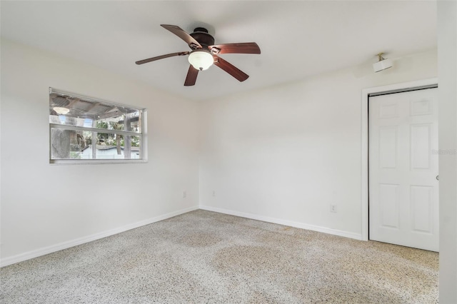 4400 Helena St NE, Saint Petersburg, FL 33703 - unfurnished room featuring a ceiling fan, speckled floor, and baseboards
