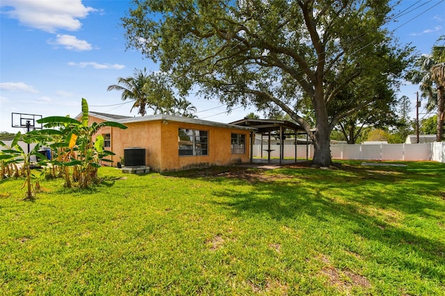 4400 Helena St NE, Saint Petersburg, FL 33703 - rear view of house featuring stucco siding and central AC