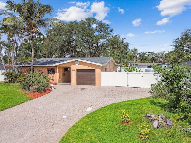 4400 Helena St NE, Saint Petersburg, FL 33703 - view of front of property with a gate, decorative driveway, a garage, and stucco siding