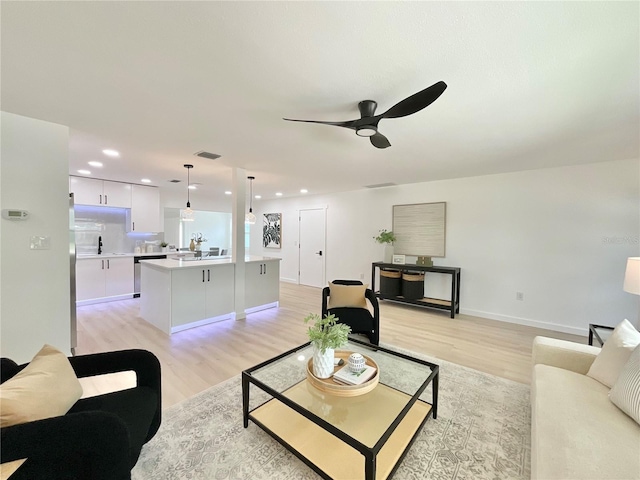 1290 Michigan Blvd, Dunedin, FL 34698 - living room featuring light wood-style flooring, a ceiling fan, and recessed lighting