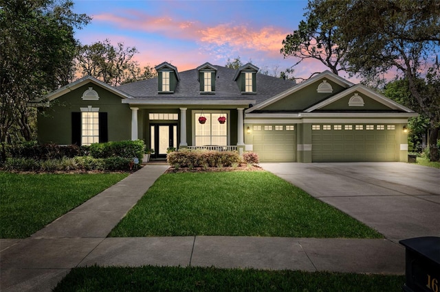 16039 Ternglade Dr, Lithia, FL 33547 - view of front facade with concrete driveway, a yard, stucco siding, a garage, and roof with shingles