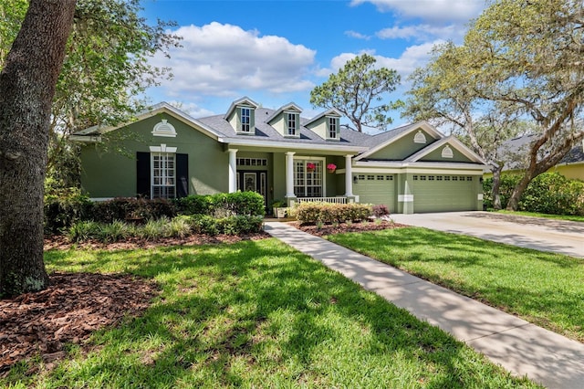 16039 Ternglade Dr, Lithia, FL 33547 - view of front of house featuring stucco siding, a garage, a front yard, concrete driveway, and covered porch