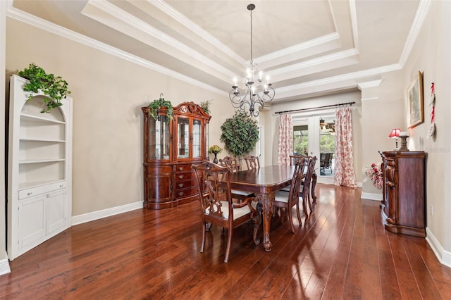 16039 Ternglade Dr, Lithia, FL 33547 - dining room featuring a tray ceiling, a chandelier, dark wood-style flooring, ornamental molding, and baseboards